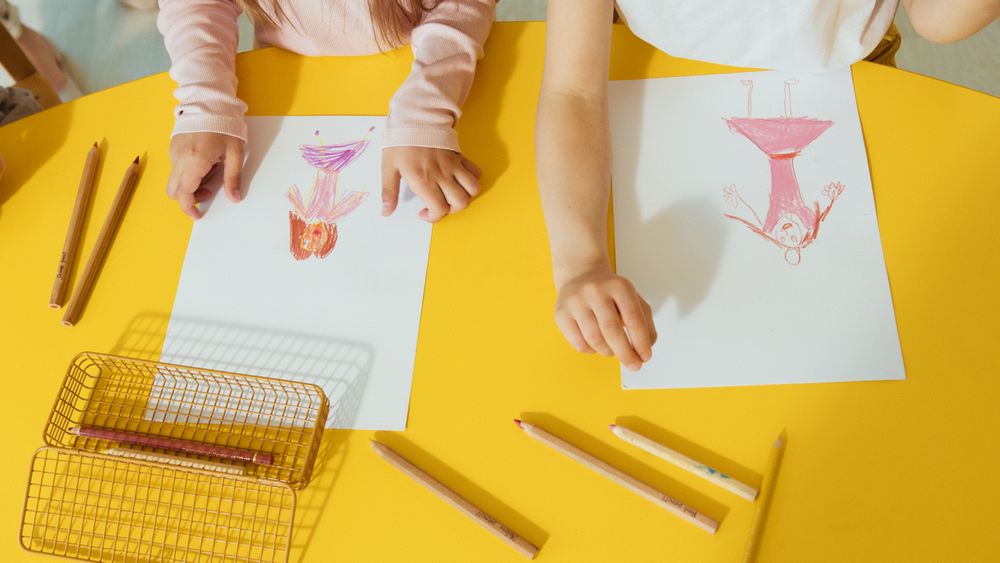 Children creating colorful drawings at a table