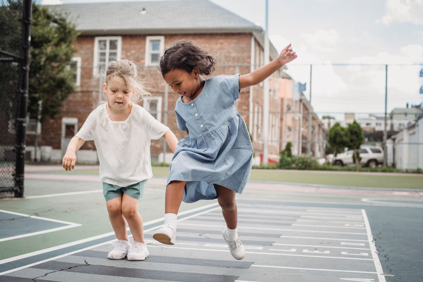 Two children enjoying an outdoor playground
